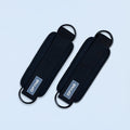 Black fabric ankle straps with curved buckle loops and printed logo patch