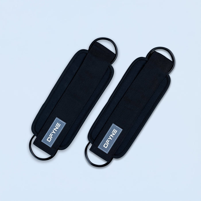 Black fabric ankle straps with curved buckle loops and printed logo patch