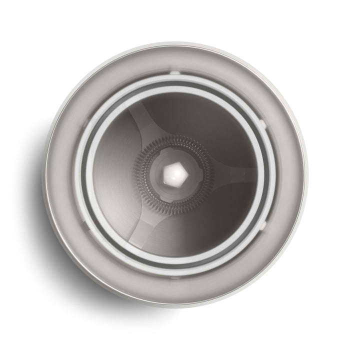 Close-up of a Philips milk frother's interior, showcasing its stainless steel whisk and frothing mechanism.