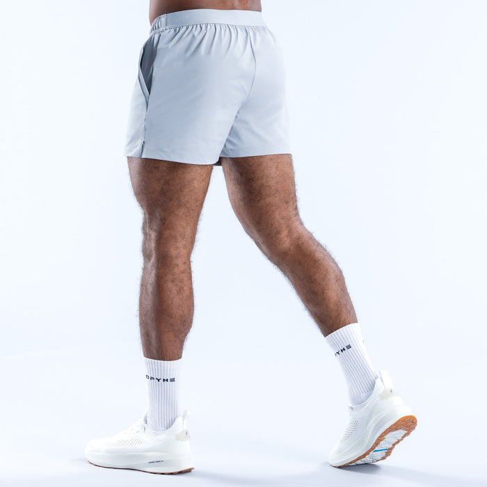 Men's light blue training shorts, 4-in inseam, back view, elastic waistband