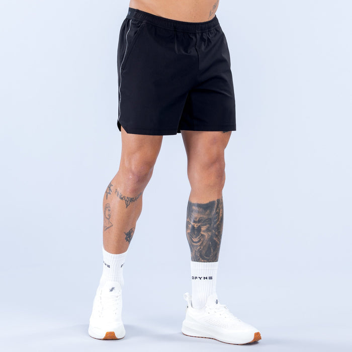 6-inch black training shorts with elastic waistband and side piping