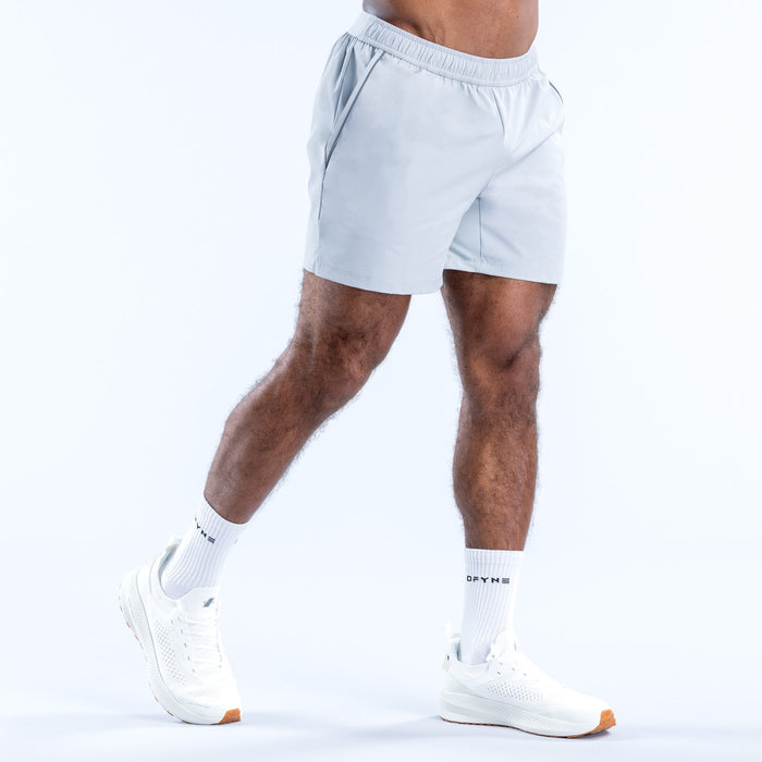 Light blue training shorts, side view, elastic waistband and logo at hem