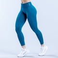 Teal high-rise performance leggings with ankle-length fit and small side logo