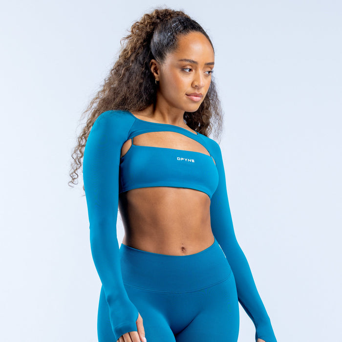 Teal long-sleeve athletic shrug with banded neckline and DRYN logo