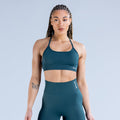 Teal sports bra with scoop neckline and racerback straps, front view
