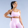 Light pink backless sports bra with crisscross open-back straps