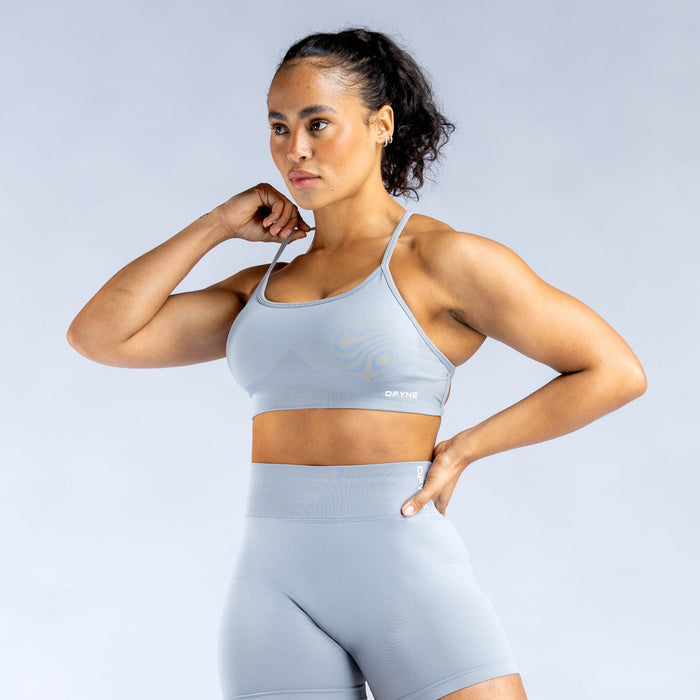 Light blue sports bra with cross-back design and slim supportive straps