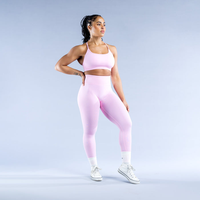 Light pink sports bra with scoop front neckline and racer-back cut