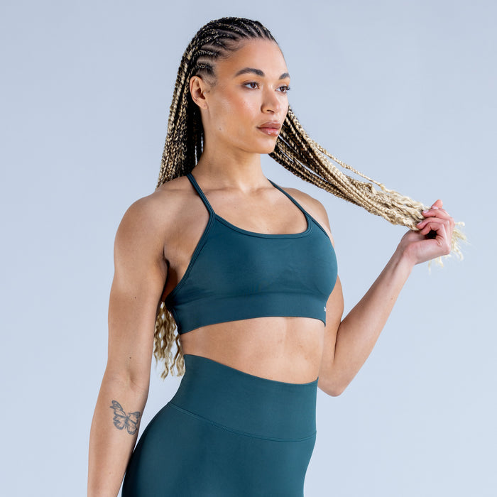 Teal sports bra with racerback straps and medium support, front view