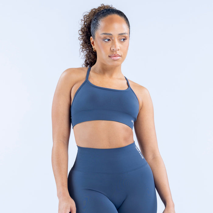 Front sports bra in dark blue with wide scoop neckline, seamless fit