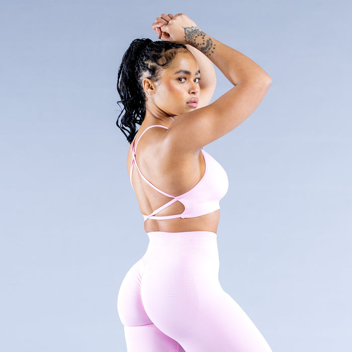 Light pink sports bra with open-back crisscross straps
