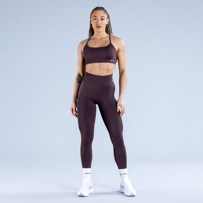 Dark plum sports bra with wide front band and racerback straps