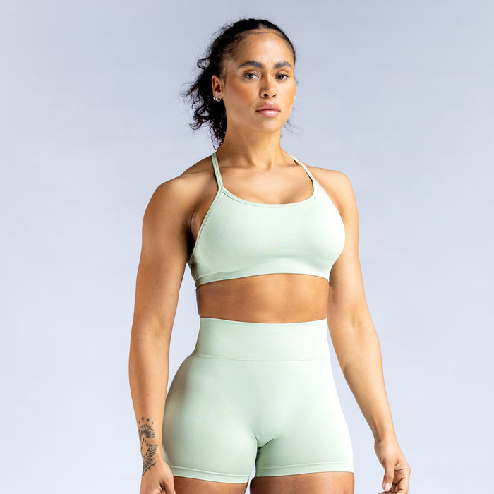 Mint green backless sports bra with crisscross straps and wide supportive band
