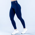 Dark blue compression leggings with small logo on upper thigh and ankle-length fit