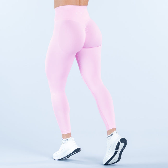 Light pink high-waist leggings with back curve detail, three-quarter view