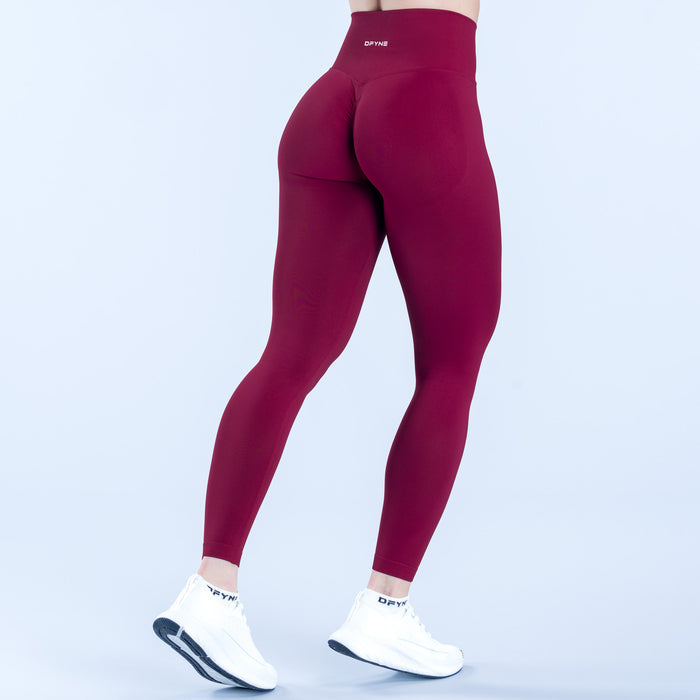 Burgundy dynamic leggings with back panel shaping and seamless full-length fit