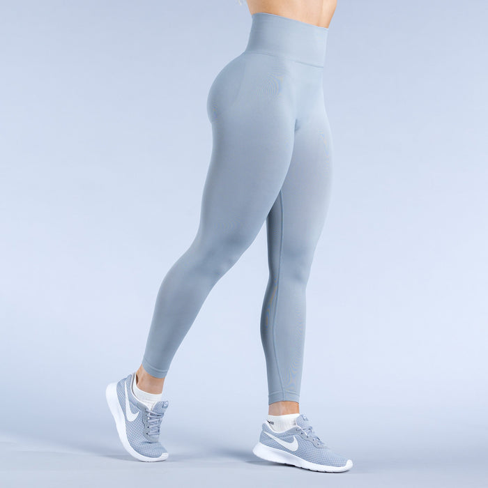 Sky-blue leggings, side view with form-fitting legs and small logo detail