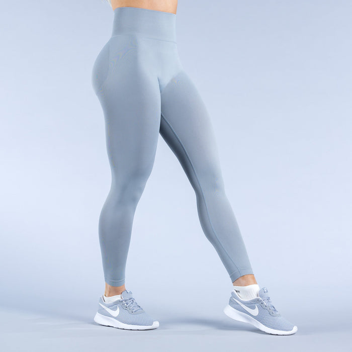 Sky-blue leggings, back view with tapered ankle cuffs and logo accents