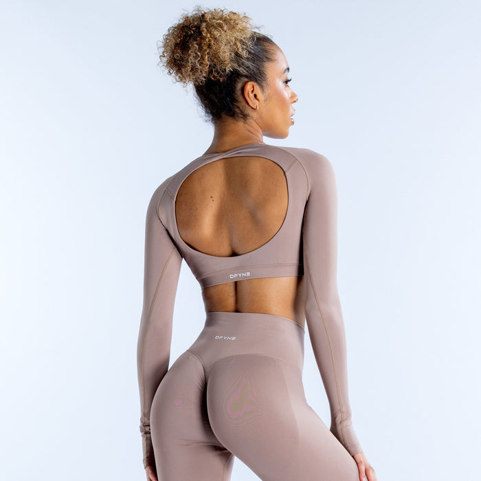 Taupe long-sleeve crop top with scooped back and fitted stretch knit.