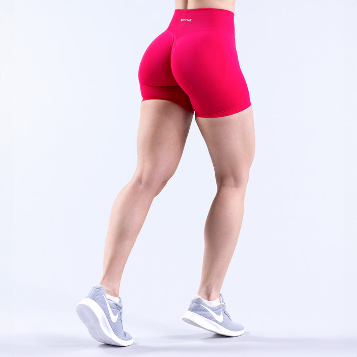 4.5-inch bright pink athletic shorts, rear fitted cut at mid-thigh length.