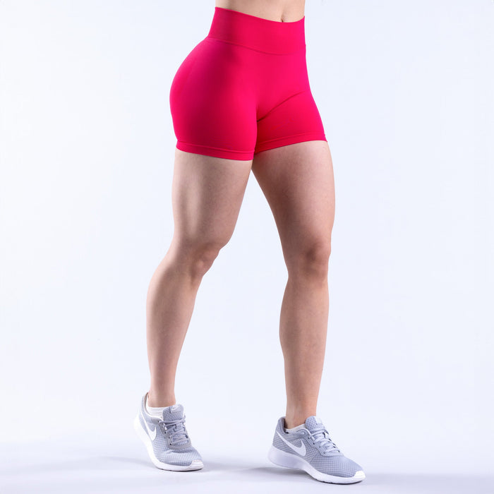 4.5-inch bright pink athletic shorts with smooth side panel and mid-thigh hem.