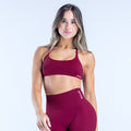 Deep burgundy twist-back sports bra with wide band and strappy front
