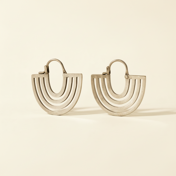 Hand cut hoop earrings with stacked curved lines and hinged backs, silver-tone finish