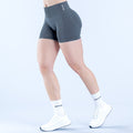 Dark gray 4.5in compression impact shorts, mid-thigh, smooth stretch fabric