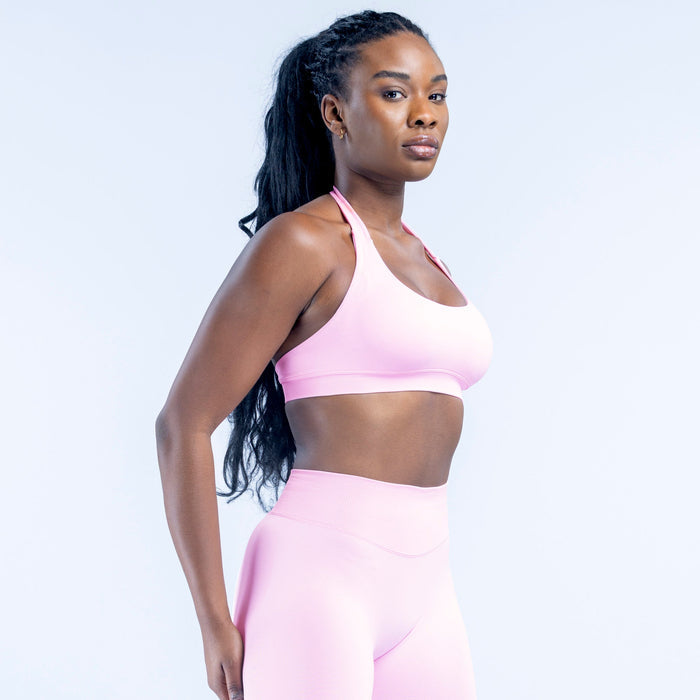 Sports bra in light pink with racerback straps and wide underband