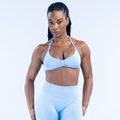 Light blue strappy impact bra with ruched center front and halter-style straps