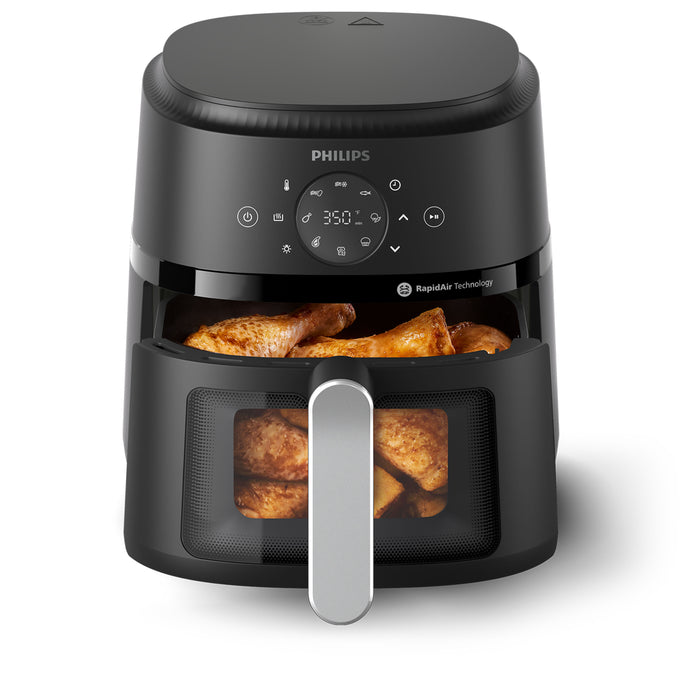 Philips air fryer with food inside on a white background