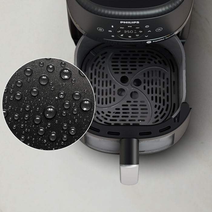 Philips air fryer with close-up of interior and water droplets on surface
