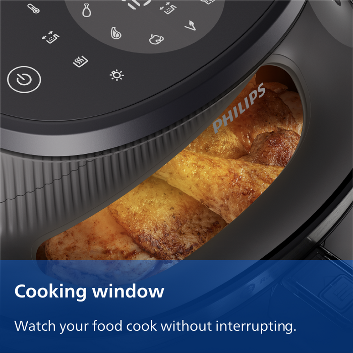 Philips kitchen appliance with a cooking window displaying food, featuring the brand name.