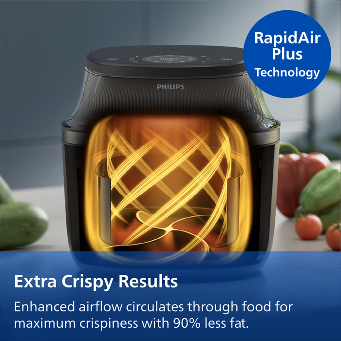 Philips air fryer with RapidAir Plus Technology, surrounded by vegetables on a kitchen counter.