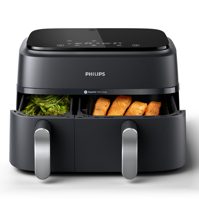 Philips air fryer with food items inside on a white background