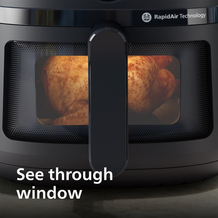Black air fryer with 'RapidAir Technology' branding and a window showing roasted chicken.