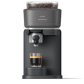 Philips Baristina dark gray automatic coffee machine with a bean hopper on top and a glass of espresso below, shown on a white background.