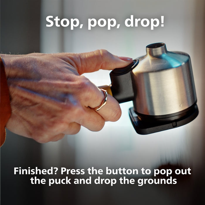 Hand holding portafilter with text instructions on a blurred background