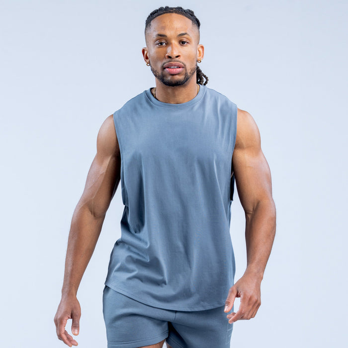 Men's blue sleeveless graphic tank top, front view with solid printed-less chest