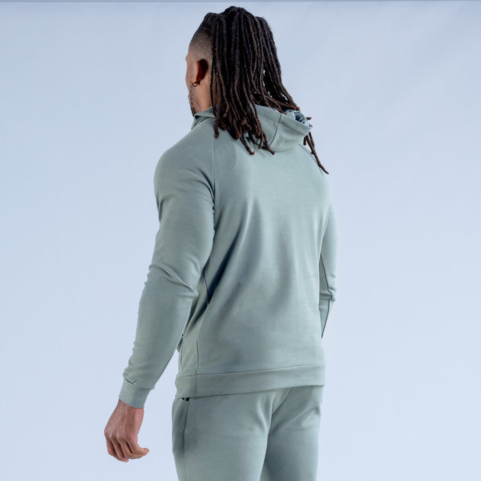 Sage green hoodie side view with drawstring hood and long sleeves