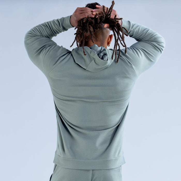Sage green hoodie back view with drawstring hood and kangaroo pocket opening