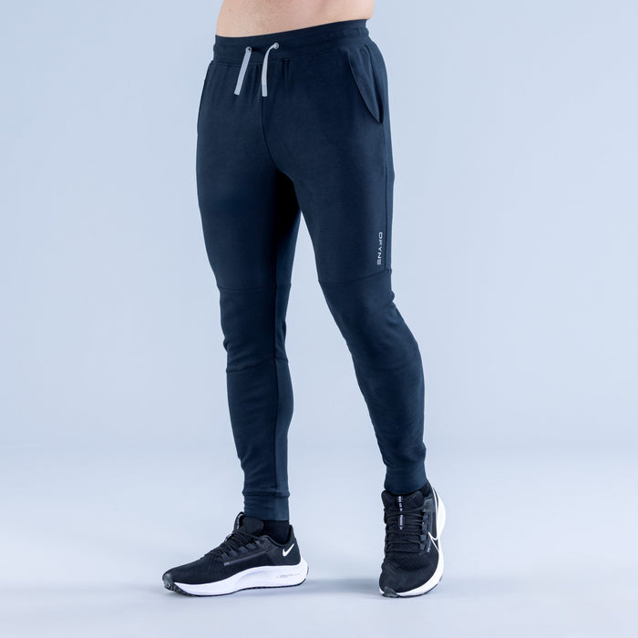 Dark navy tapered jogger pants with elastic waistband, drawstring, and zip pockets
