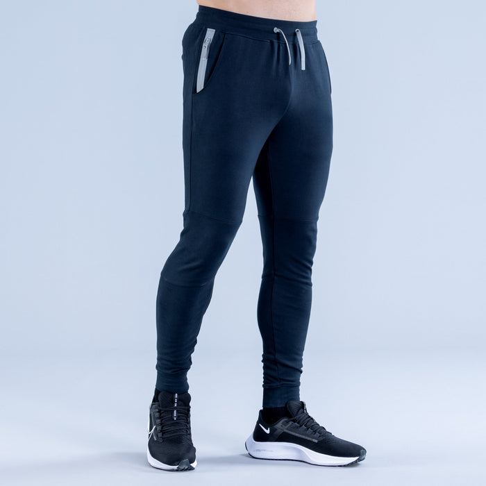 Dark navy tapered jogger pants with drawstring waist and side seams