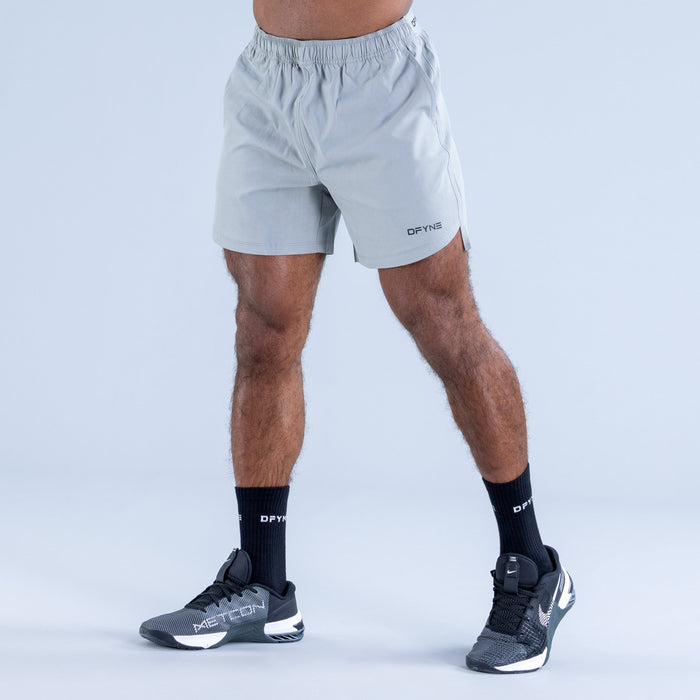 Men's light blue training shorts with elastic waistband and DPYNE logo on leg