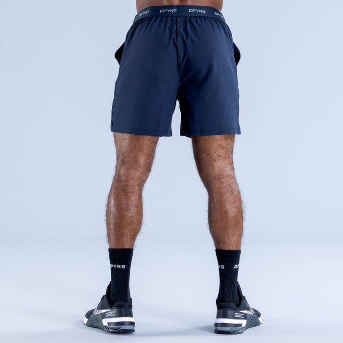 Navy training shorts with elastic waistband, back view with small logos