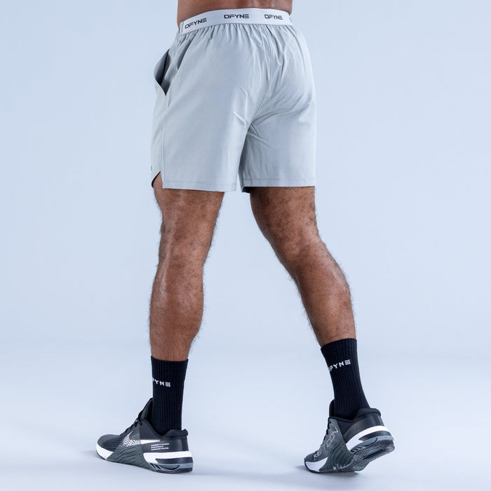 Men's light blue training shorts, back view, elastic waistband and DPYNE logo