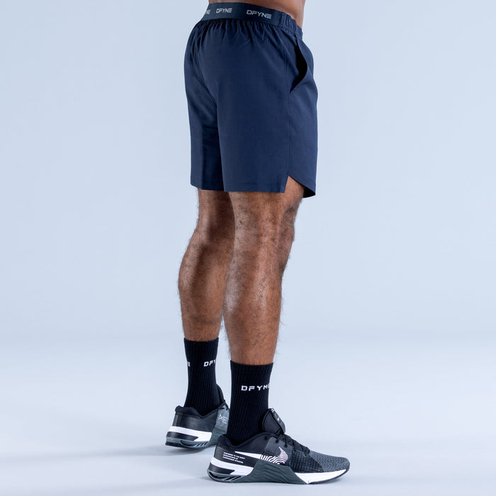 Navy training shorts with elastic waistband and straight hem, back view