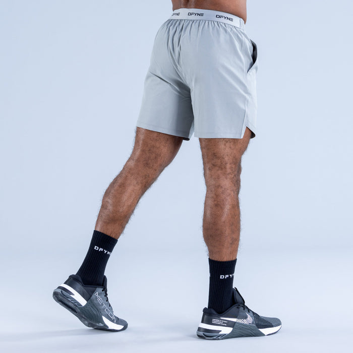 Men's light blue training shorts, rear view with DPYNE waistband branding