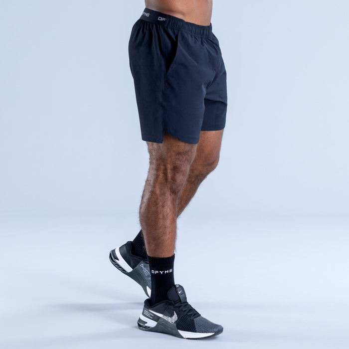 Dark navy training shorts with elastic waistband and knee-length hem