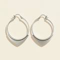 Silver wire hoop earrings with small spearhead-style charm at the bottom